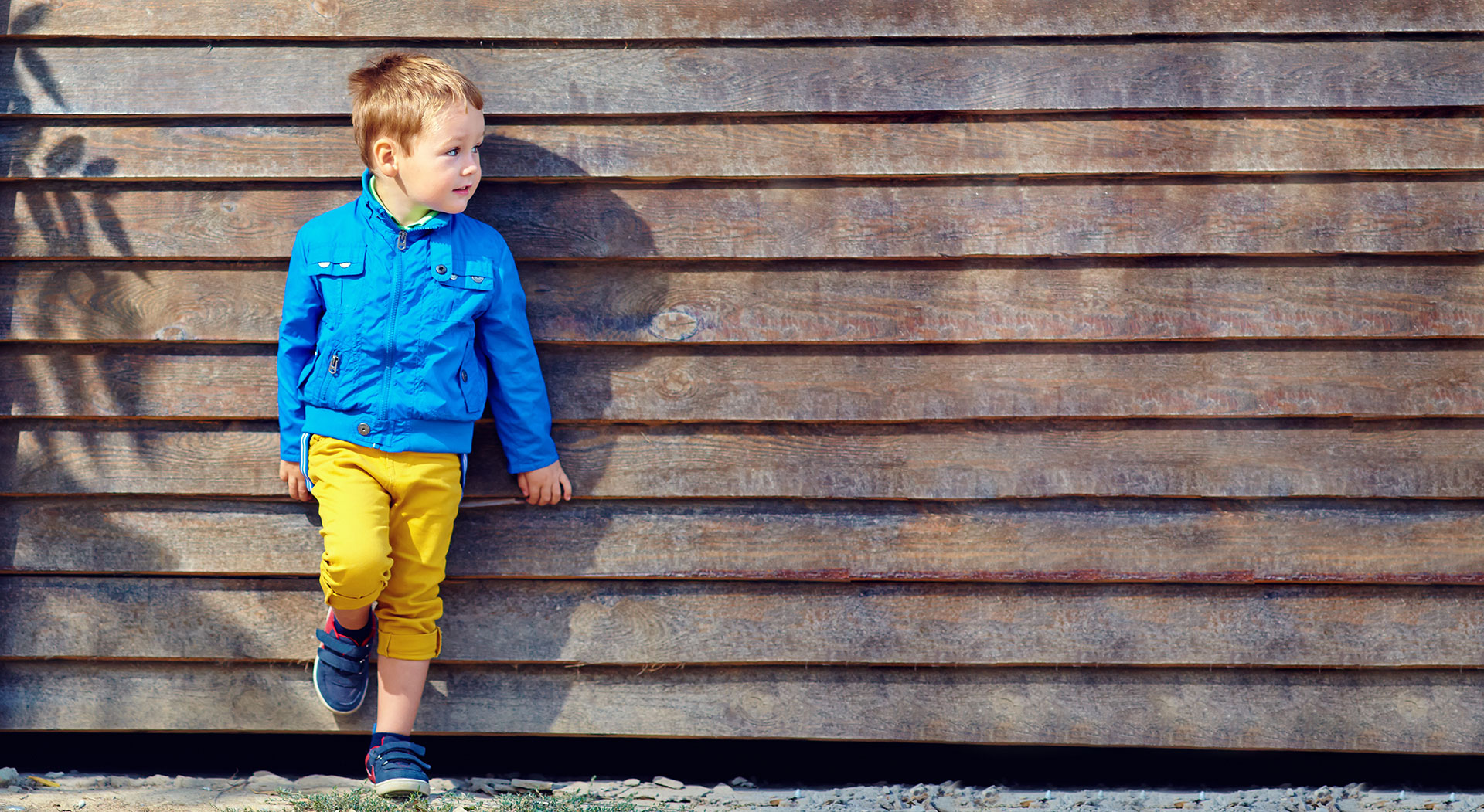 Boy leaning against wall
